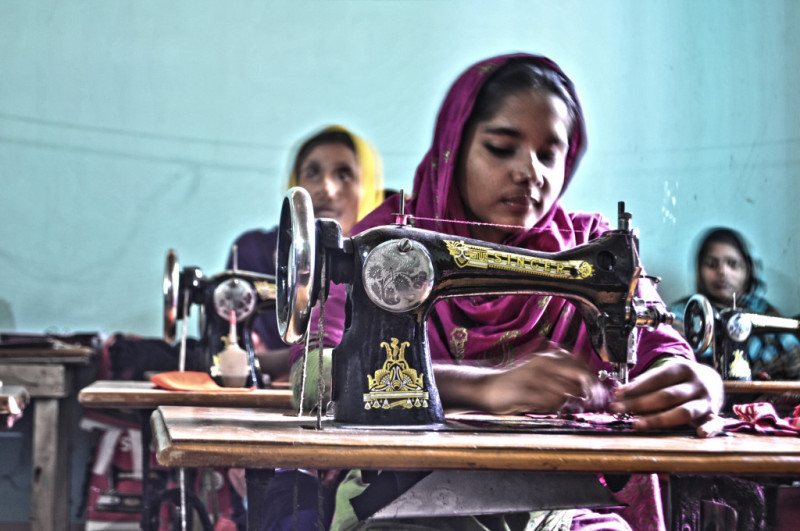 Factory worker sewing Clothes